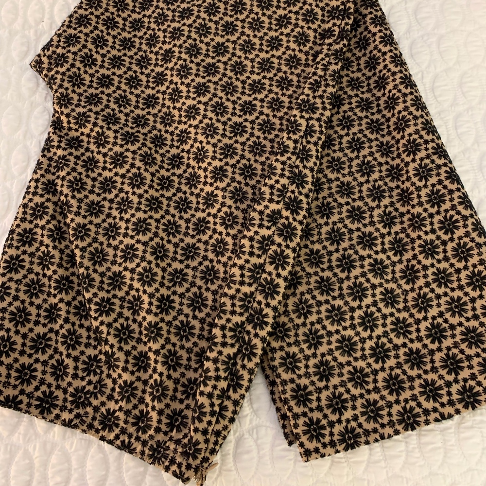 Creme pants with black embroidery.